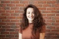 Happy woman with long lush hair. full of happiness. cheerful girl on brick wall background