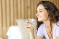 Happy woman looking away holding a water glass Royalty Free Stock Photo