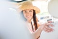 Happy woman looking back while driving car