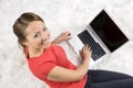 Happy woman looking backward with laptop