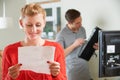 Happy Woman Looking At Bill For TV Installation Royalty Free Stock Photo