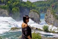 Happy woman looking at camera in Rhine Falls Royalty Free Stock Photo