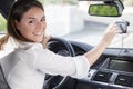 happy woman looking at gps on car