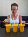 Happy Woman Looking At Mango Lassi Drink Inside Indian Restaurant
