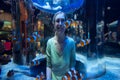 Happy woman looks at clown fish through glass