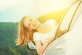 Happy woman looks out the car window on nature Royalty Free Stock Photo