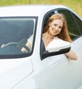 Happy woman looks out the car window on nature Royalty Free Stock Photo