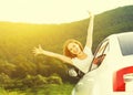 Happy woman looks out the car window on nature Royalty Free Stock Photo