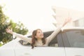 Happy woman looks out the car window on nature summer Royalty Free Stock Photo