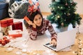 Happy woman lying on floor with laptop Royalty Free Stock Photo