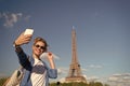 Happy woman make selfie at eiffel tower in paris, france