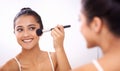 Happy woman, makeup brush and face in mirror for cosmetics, grooming or beauty in bathroom at home. Female person smile