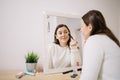 Happy woman makeup in front of a mirror Royalty Free Stock Photo