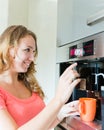 Happy woman making coffee cup machine Royalty Free Stock Photo