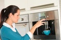 Happy woman making coffee machine kitchen cup Royalty Free Stock Photo