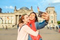 Happy woman making selfie on background of Reichstag Bundestag building in Berlin. Travel and love concept in Europe