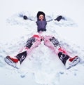 Happy woman making snow angel Royalty Free Stock Photo