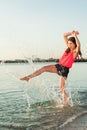 Happy woman making splashes on the beach Royalty Free Stock Photo