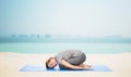 Happy woman making yoga in child pose on mat Royalty Free Stock Photo