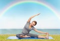 Happy woman making yoga and stretching on mat Royalty Free Stock Photo