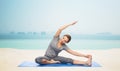 Happy woman making yoga and stretching on mat Royalty Free Stock Photo