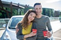 Happy woman and man hugging her standing with coffee. Royalty Free Stock Photo