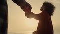 Happy woman and man walking on beach at sunset. Lovely couple holding hands Royalty Free Stock Photo