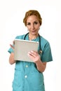 Happy woman md emergency doctor or nurse posing smiling using digital tablet pad Royalty Free Stock Photo