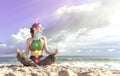 Happy woman meditates on the seashore. Girl in lotus position