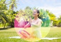 Happy woman meditating in summer park over aura