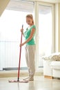 Happy woman with mop cleaning floor at home Royalty Free Stock Photo