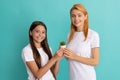 Happy woman mother and daughter child smile holding pot plant blue background, mothering