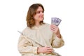 Happy woman musician with money in us dollars at home on sofa in liv Royalty Free Stock Photo