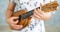 Happy woman musician playing ukulele in studio Royalty Free Stock Photo
