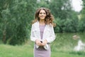 A happy woman in nature. Portrait of a beautiful girl in close-up on the background of the lake. Young smiling woman outdoor Royalty Free Stock Photo