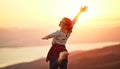 Happy woman  dances, jump, rejoices, laughs  on sunset in nature Royalty Free Stock Photo