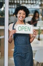 Happy woman, open sign and portrait of small business owner or waitress at cafe for morning or ready to serve. African Royalty Free Stock Photo