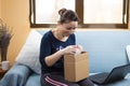 Happy woman opens her package ordered online