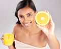 Happy woman, orange juice and fruit in portrait, health and nutrition with healthy drink and diet on studio background Royalty Free Stock Photo