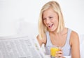 Happy woman, orange juice and reading newspaper on bed for headlines, energy and health body with wellness. Blonde hair Royalty Free Stock Photo