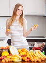 Happy woman with oranges and other fruits