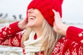 Happy woman outdoors pulling beanie over eyes Royalty Free Stock Photo