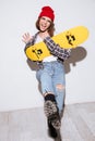 Happy woman over white background holding skateboard Royalty Free Stock Photo