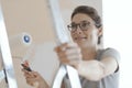 Happy woman painting walls in her new apartment Royalty Free Stock Photo