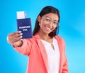 Happy woman, passport or ticket for travel, flight or USA documents against a blue studio background. Portrait of female