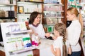 Happy woman pharmacist helping customers