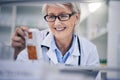 Happy woman, pharmacist and reading medication on shelf for inventory, diagnosis or prescription at pharmacy. Mature Royalty Free Stock Photo