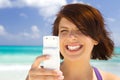 Happy woman with phone on the beach Royalty Free Stock Photo