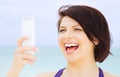 Happy woman with phone on the beach Royalty Free Stock Photo