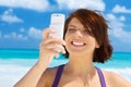 Happy woman with phone on the beach Royalty Free Stock Photo